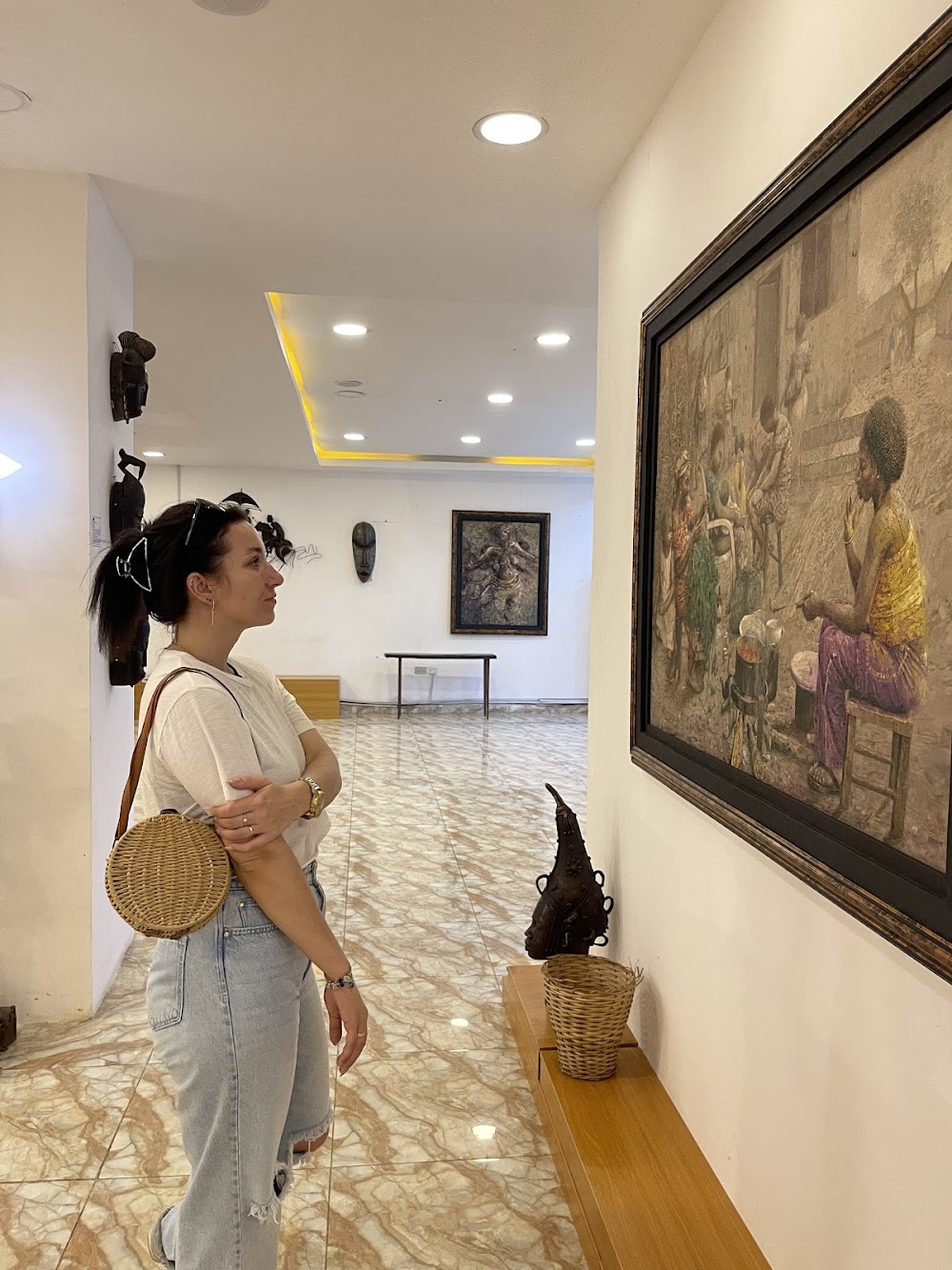 Visitor viewing African art in an Abuja gallery